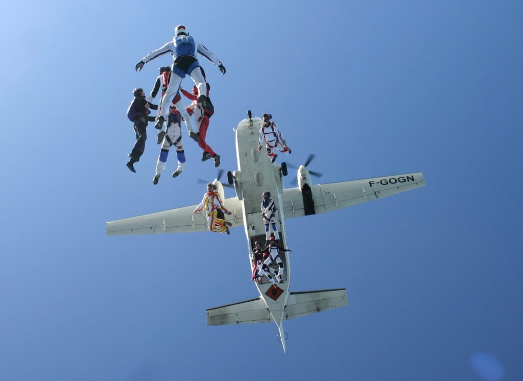 Skydivers exiting aircraft